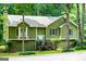 Exterior of home with green siding, shrubbery, trees, and grass at 133 Deerfield Ln, Carrollton, GA 30116