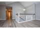 Upstairs hallway with updated flooring and natural light at 133 Deerfield Ln, Carrollton, GA 30116
