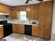 A well-lit kitchen featuring wooden cabinets and modern black appliances at 133 Deerfield Ln, Carrollton, GA 30116