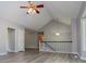 Open floorplan living room with fan and vaulted ceiling at 133 Deerfield Ln, Carrollton, GA 30116