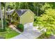 Aerial view of home with driveway, garage, and mature trees at 133 Deerfield Ln, Carrollton, GA 30116