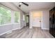 Sunroom with many windows and gray wood-look floors at 133 Deerfield Ln, Carrollton, GA 30116