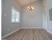 A dining room is illuminated by a chandelier and features wood floors and light gray walls at 325 Berry Ct, Villa Rica, GA 30180