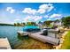 Lakefront community featuring a private dock and covered pontoon boat on a sunny day with beautiful blue sky and clouds at 325 Berry Ct, Villa Rica, GA 30180