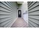 A welcoming front door is adorned with a glass pane, set between light green siding at 325 Berry Ct, Villa Rica, GA 30180