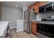 Kitchen area features modern stainless steel appliances, including a refrigerator, microwave, and oven at 325 Berry Ct, Villa Rica, GA 30180