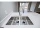 A modern kitchen sink with stainless steel features sits beneath a light countertop, inviting functionality at 325 Berry Ct, Villa Rica, GA 30180