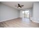 A spacious living room boasts wood floors, a ceiling fan, and sliding glass doors to a balcony at 325 Berry Ct, Villa Rica, GA 30180
