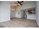 An open living area features a ceiling fan, pendant lighting, and wood-look floors at 325 Berry Ct, Villa Rica, GA 30180