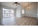 A spacious living area is lit by a ceiling fan and has a sliding glass door to the outside at 325 Berry Ct, Villa Rica, GA 30180