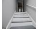 Well-lit staircase with stylish grey accents, creating a welcoming transition between floors at 325 Berry Ct, Villa Rica, GA 30180