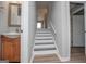 A bright staircase features wood floors, gray painted steps, and white risers at 325 Berry Ct, Villa Rica, GA 30180