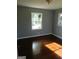 Bedroom featuring hardwood floors and a large window with natural light at 5243 Eubanks Dr, Lake City, GA 30260