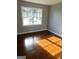 Bedroom featuring hardwood floors and a large window with natural light at 5243 Eubanks Dr, Lake City, GA 30260