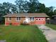 Charming brick ranch with red trim and an attached garage at 5243 Eubanks Dr, Lake City, GA 30260