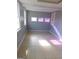 Spacious living room with tile flooring, light gray walls, and bright windows at 5243 Eubanks Dr, Lake City, GA 30260
