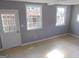 Welcoming living room with tile flooring, bright windows, and a rear door at 5243 Eubanks Dr, Lake City, GA 30260