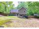 Green backyard surrounded by mature trees and a wooden fence, providing peace and privacy at 10 Queens Ct, Sharpsburg, GA 30277