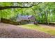 Secluded backyard with mature trees, patio and wooden fence; great for outdoor entertaining and privacy at 10 Queens Ct, Sharpsburg, GA 30277