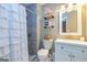Bathroom featuring a tiled shower, white vanity, and decorative shelves at 10 Queens Ct, Sharpsburg, GA 30277