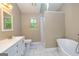 Modern bathroom with soaking tub, walk-in shower, and vanity, creating a spa-like retreat at 10 Queens Ct, Sharpsburg, GA 30277