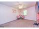 Bright bedroom featuring carpet, ceiling fan, desk, and a map wall decoration at 10 Queens Ct, Sharpsburg, GA 30277
