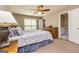 Cozy bedroom featuring carpet, ceiling fan, and ensuite bathroom, offering comfort and convenience at 10 Queens Ct, Sharpsburg, GA 30277