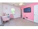 Pink bedroom featuring carpet, a ceiling fan, and a wall mounted TV, creating a fun space at 10 Queens Ct, Sharpsburg, GA 30277