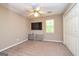 Neutral bedroom featuring carpet, ceiling fan, closet, and a TV above a storage unit at 10 Queens Ct, Sharpsburg, GA 30277