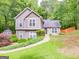Charming two-story home with a landscaped yard, quaint shed, and welcoming walkway at 10 Queens Ct, Sharpsburg, GA 30277