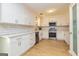 The renovated kitchen features white cabinets, stainless steel appliances, and subway tile at 10 Queens Ct, Sharpsburg, GA 30277
