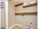 A laundry room with wood shelving and a light wood colored flooring provides functionality and storage at 10 Queens Ct, Sharpsburg, GA 30277