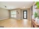 Bright living room with hardwood floors, large window, and modern light fixtures at 10 Queens Ct, Sharpsburg, GA 30277