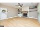 Living room features decorative fireplace with built-in shelving and laminate wood flooring at 10 Queens Ct, Sharpsburg, GA 30277