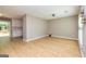 Open-concept living room featuring hardwood floors and sliding glass doors to the backyard at 10 Queens Ct, Sharpsburg, GA 30277