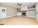 Inviting living room featuring a fireplace, built-in shelving, and access to the front door at 10 Queens Ct, Sharpsburg, GA 30277