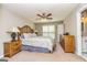 Serene main bedroom with ceiling fan, wood furniture, and ensuite bathroom at 10 Queens Ct, Sharpsburg, GA 30277
