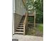 Exterior view of the backyard porch with stairs, a wooden deck, and a door leading into the house at 937 Sw Metropolitan Sw Pkwy, Atlanta, GA 30310