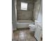 Well-maintained bathroom features a tub, window, and neutral tiling at 937 Sw Metropolitan Sw Pkwy, Atlanta, GA 30310