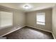 Neutral bedroom with carpet, two windows with blinds, and neutral paint at 2165 Pemberton Rd, Atlanta, GA 30331