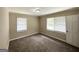 A carpeted bedroom with neutral walls, with two windows creating a light-filled interior at 2165 Pemberton Rd, Atlanta, GA 30331