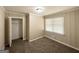 A carpeted bedroom with neutral walls, a window, and a closet for organized storage at 2165 Pemberton Rd, Atlanta, GA 30331