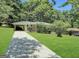Charming ranch home with a long driveway and a covered carport surrounded by lush greenery at 2165 Pemberton Rd, Atlanta, GA 30331