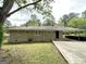 Single story brick home with carport and mature landscaping at 2165 Pemberton Rd, Atlanta, GA 30331
