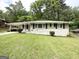 White brick home with black shutters and a well-manicured lawn provides a welcoming exterior at 2165 Pemberton Rd, Atlanta, GA 30331