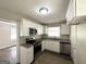 Modern kitchen with stainless steel appliances, white cabinetry, and updated countertops at 2165 Pemberton Rd, Atlanta, GA 30331