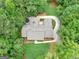 Aerial view of the property with a circular driveway and lush landscaping at 230 Shorewood Ct, Mcdonough, GA 30252