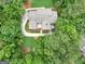 An aerial view showing a large home and backyard with a trampoline and outdoor fireplace at 230 Shorewood Ct, Mcdonough, GA 30252