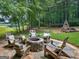 Inviting backyard area with a stone fire pit and seating, perfect for outdoor gatherings and relaxation at 230 Shorewood Ct, Mcdonough, GA 30252