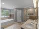 Elegant bathroom with a soaking tub, double vanity, and modern shower at 230 Shorewood Ct, Mcdonough, GA 30252